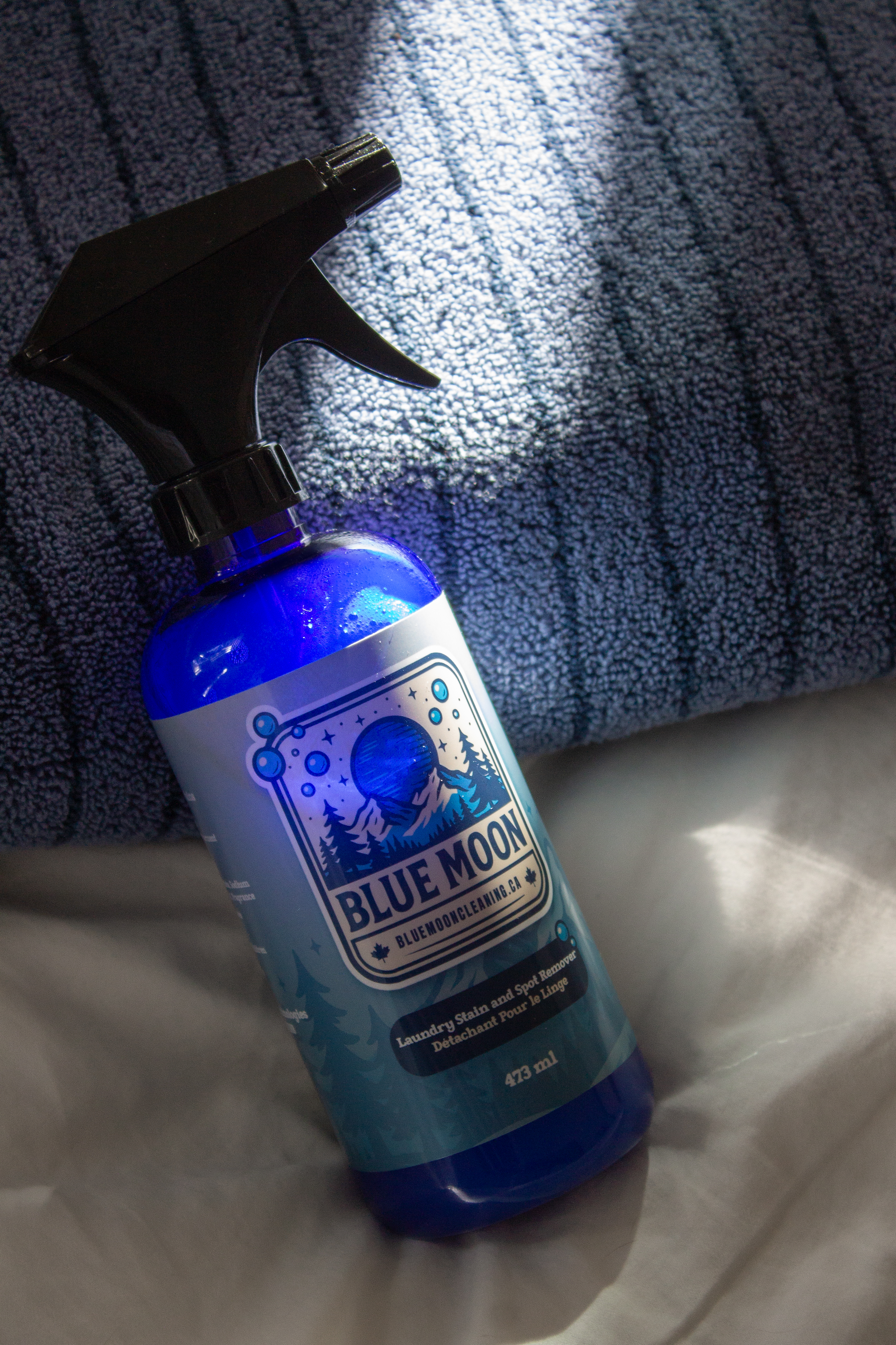 Blue Moon cleaning spray bottle on a textured surface